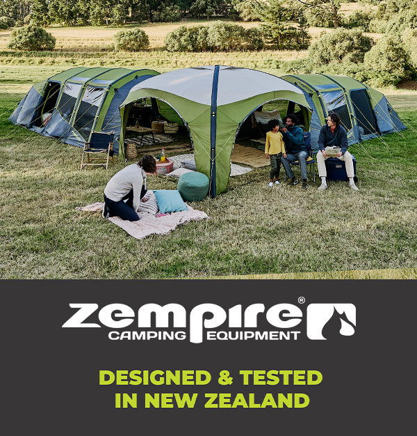 Large green family camping tent set up in an open grassy field, with people relaxing outside and a Zempire Camping Equipment promotional banner displayed below.