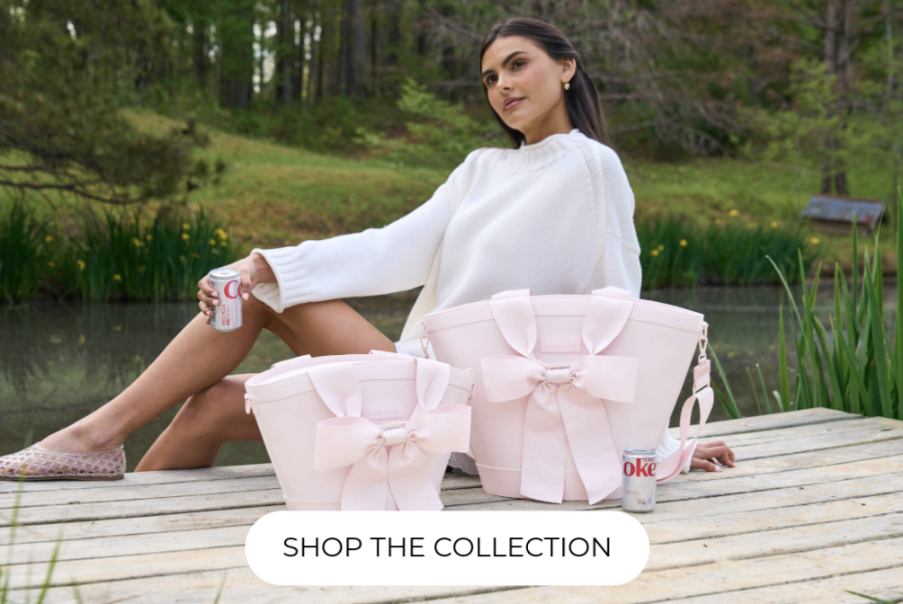 A woman lounging on a dock with two Jelly Cooler Totes in front of her.