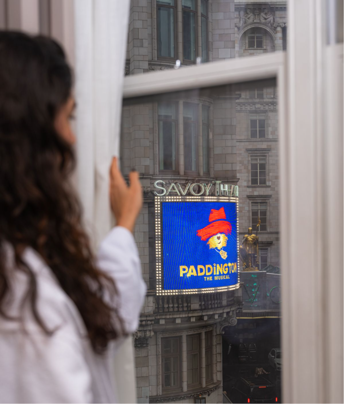 Woman views Paddington theater sign