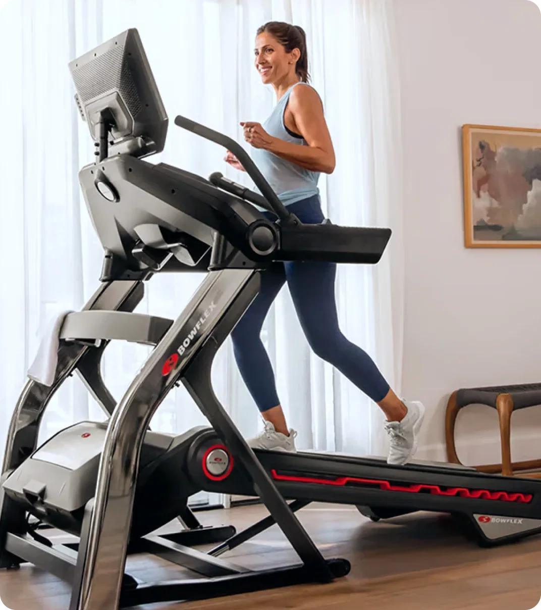 Woman running on a Bowflex treadmill at home.