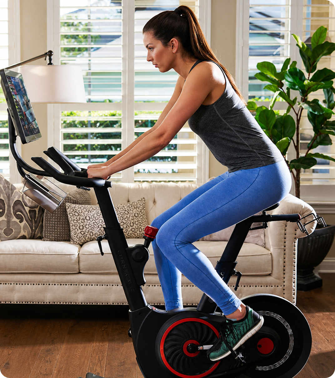 Woman exercising at home on an indoor bike.
