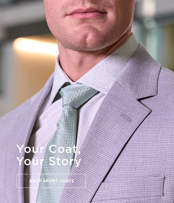 Man posing in a gray suit, button on the image says to shop sport coats