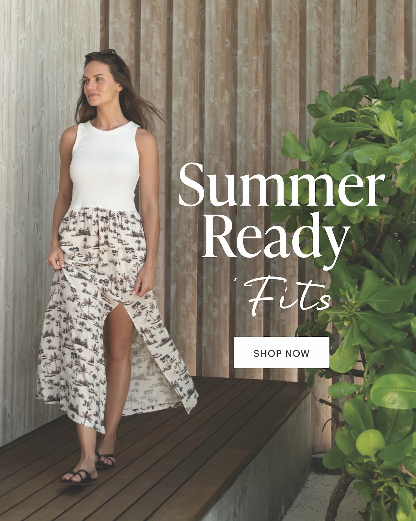 Summer Ready 'Fits: Shop Now. Woman in palm print dress on wooden deck. 