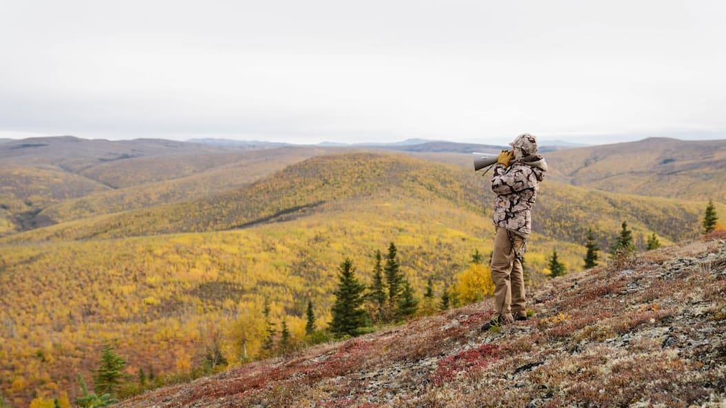 man calling moose in alaska's mountain range