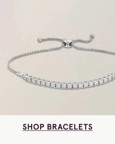 Silver bolo bracelet with adjustable pull-string clasp & line of bar-set round stones. Click here to shop bracelets