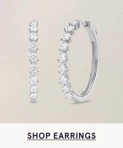 Shared-prong diamond inside-out hoops set in silver. Click here to shop earrings