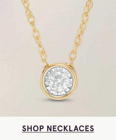 Round diamond composite pendant with bezel setting on gold chain.  Click here to shop necklaces