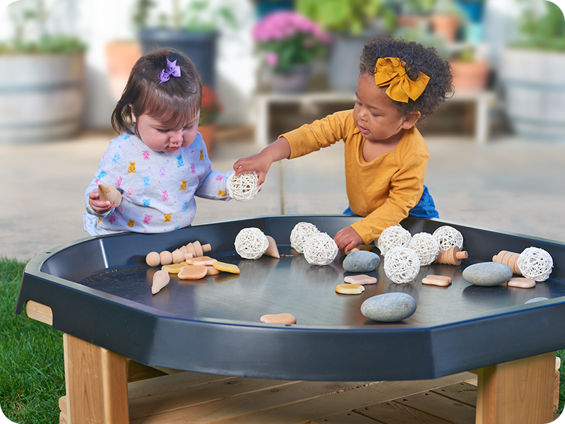 Girls playing with Tuff Tray and sensory materials