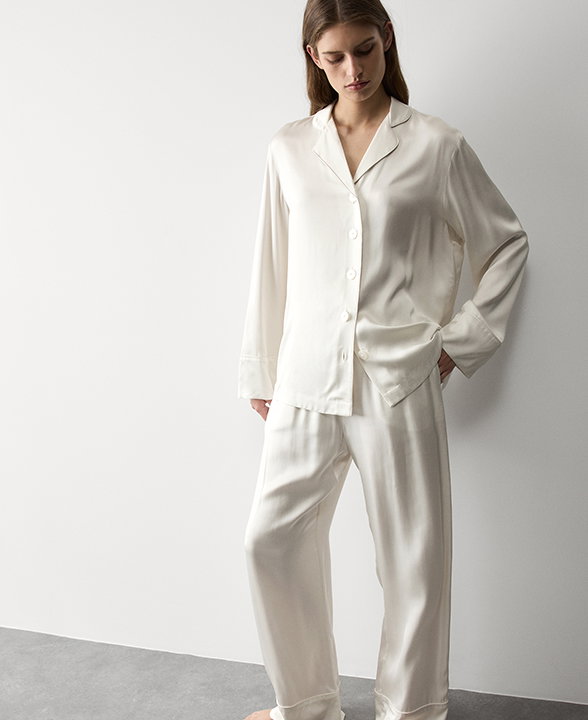 Woman wearing an Ivory Satin Revere Pyjama Set