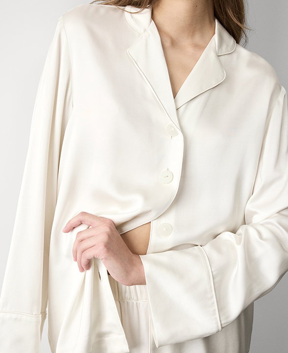 Woman wearing an Ivory Satin Revere Pyjama Set