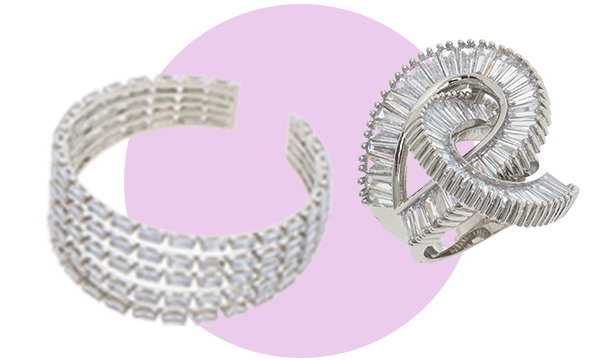 Two pieces of silver jewellery displayed on a light background with a soft purple circle, featuring intricate textured designs and curved shapes.