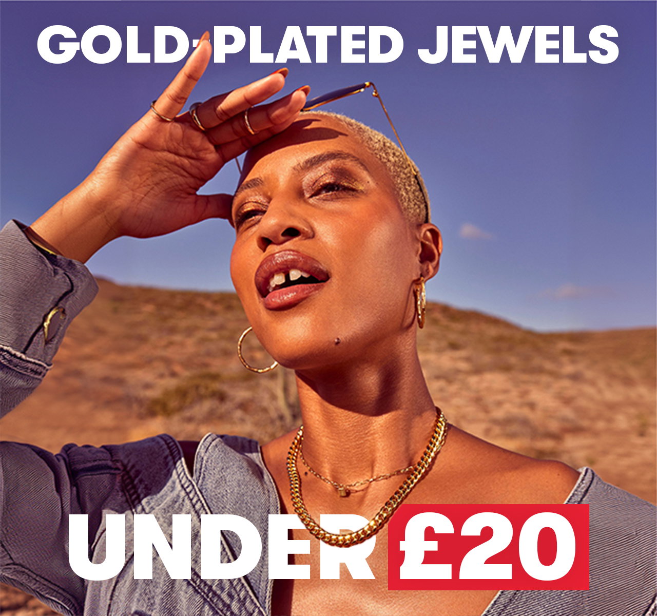 Person wearing gold-plated jewellery, including layered chains and hoop earrings, poses outdoors. Image text says, “Gold Plated Jewels Under £20”.