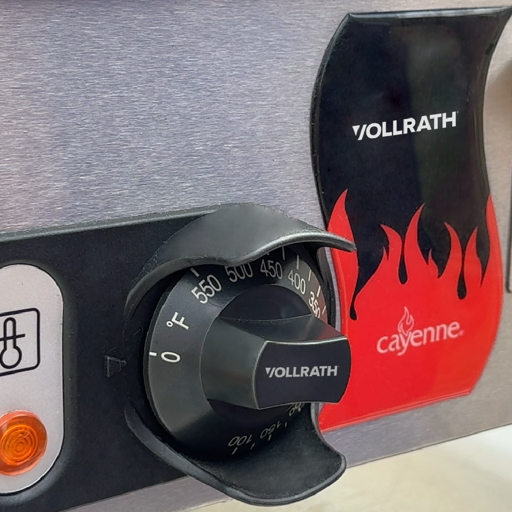 Vollrath Cayenne® commercial griddle temperature control knob and indicator light shown while in use.