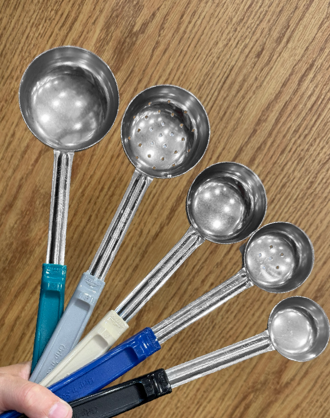 Vollrath stainless steel spoodles in assorted sizes with color‑coded handles displayed on a woodgrain surface, including both solid and perforated bowl designs.