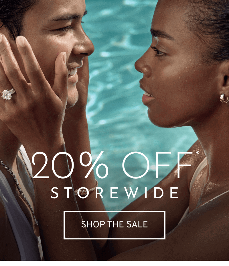 Model wearing engagement ring holding their partner’s face in a pool. 20% OFF* Storewide. Click to Shop the Sale