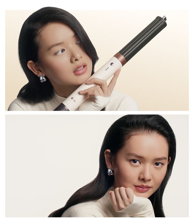 Model holds the Dyson Airwrap Co-anda2x multi-styler and dryer and shows off her styled hair