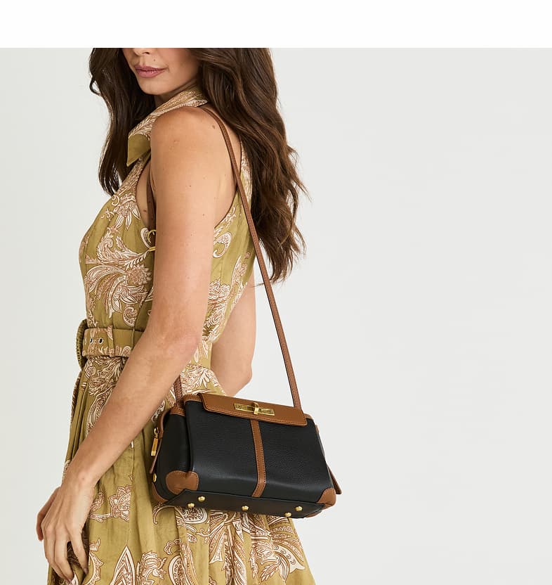 Model wearing the Hammitt Charlotte Med top handle bag in Black/Tan Pebble leather.