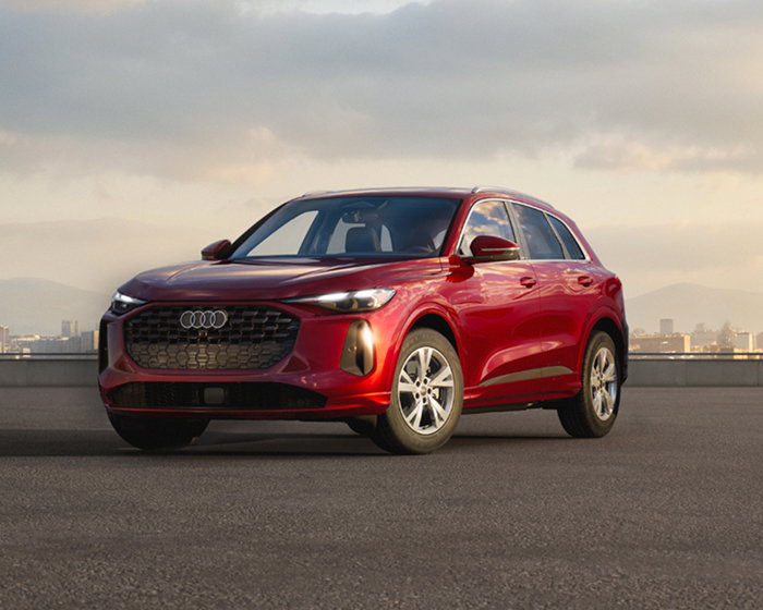 A Grenadine Red Metallic Audi Q5 stands alone on a building rooftop. See inventory.