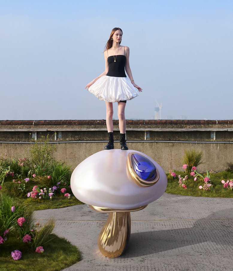 A model stands on a super-sized mushroom pearl charm