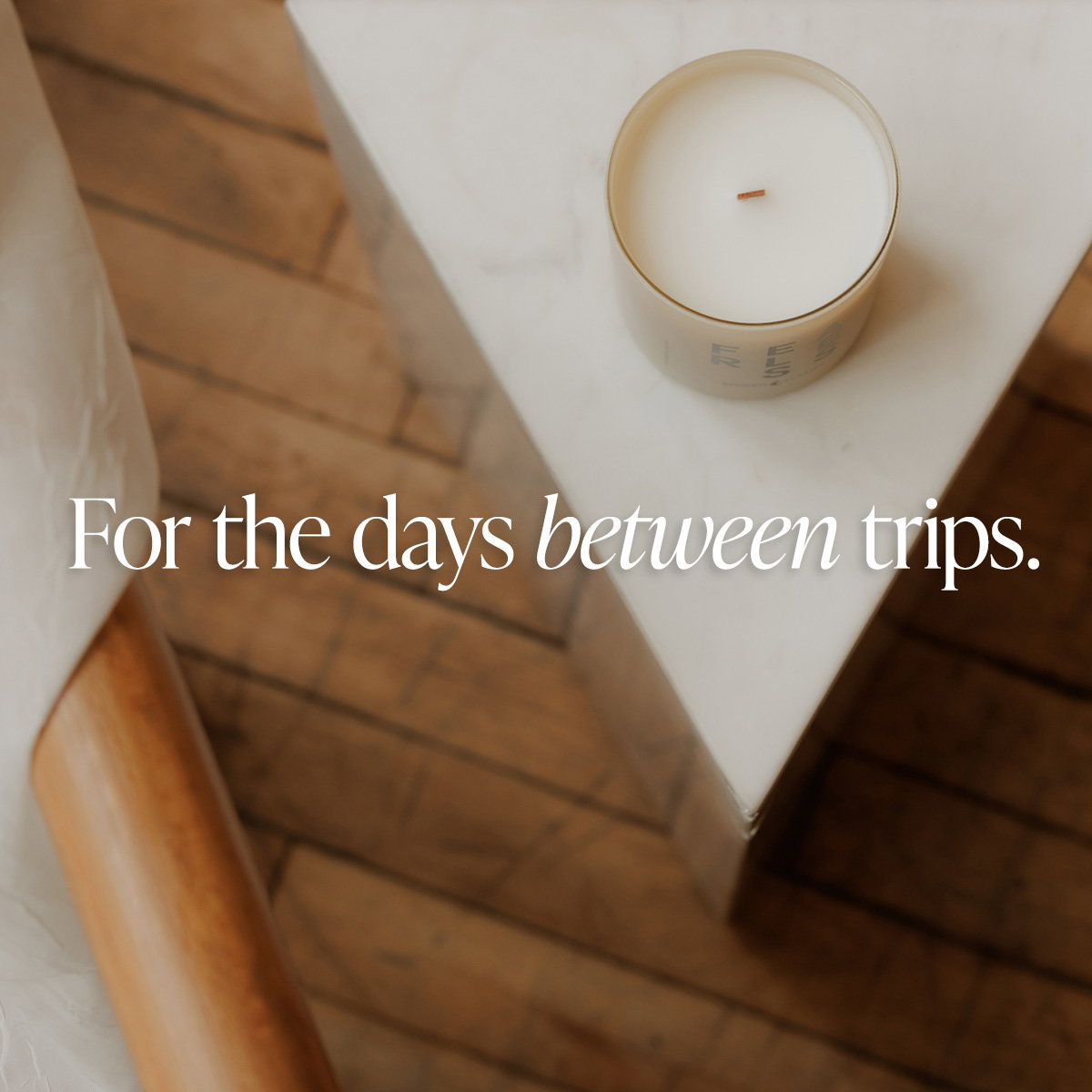 Image: Overhead view of a Spoken Flames wooden wick candle on an accent table.