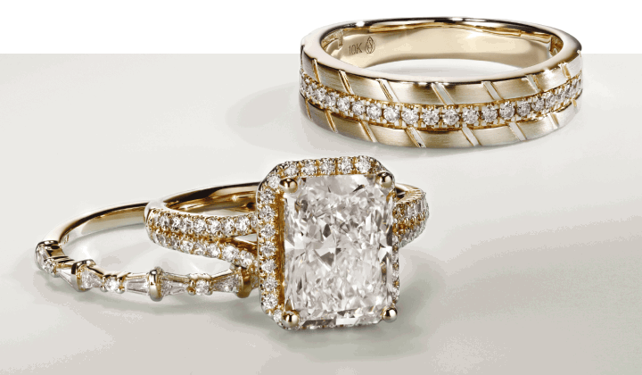 Two gold diamond rings and an engagement ring with a radiant cut center stone.