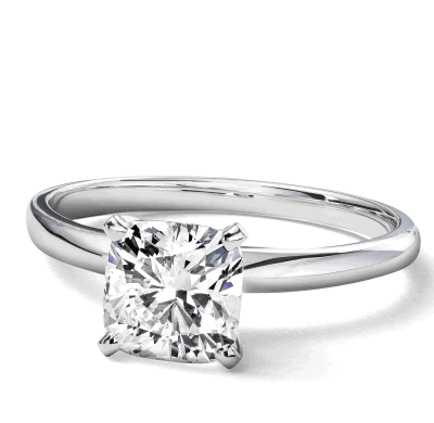 A white metal solitaire ring with a princess cut center stone.