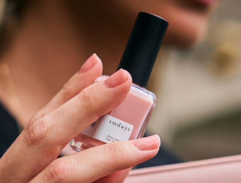 sheer pink non-toxic nail polish on hand