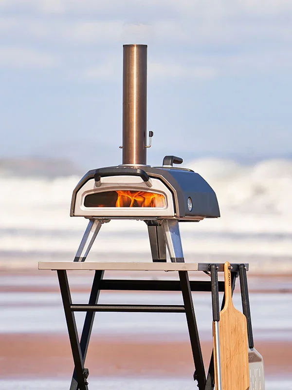 Ooni Karu 2 on an Ooni Folding Table on the beach.
