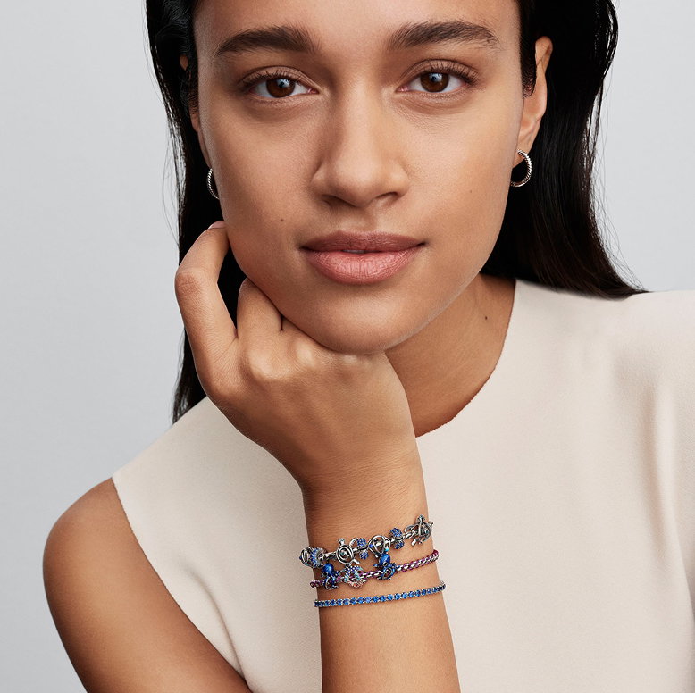Model wearing bracelets with charms