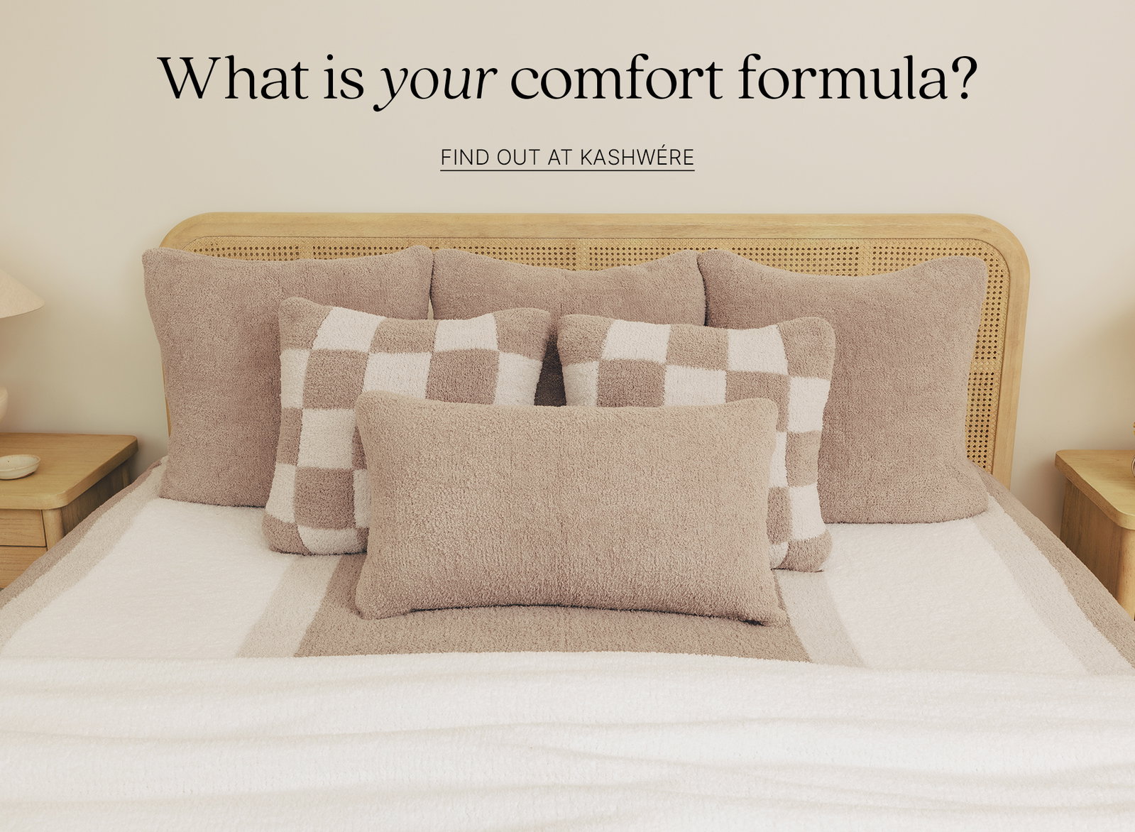 What is your comfort formula? Find out at Kashwere. Image of bed with pillows and blankets.