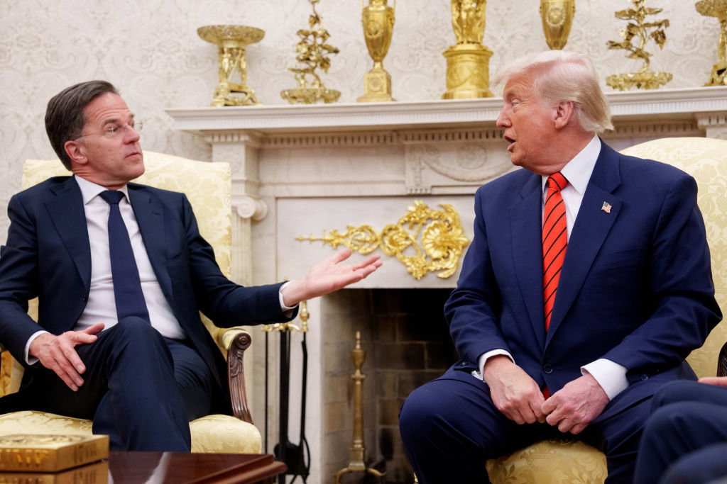 Trump, in a navy suit and red/blue striped tie seems to shout at NATO Secretary General Mark Rutte, who is seated next to Trump in the Oval Office.