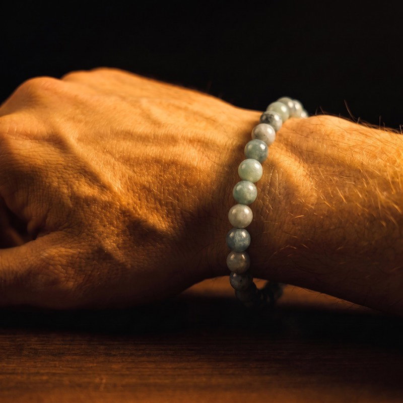 One-of-a-kind bracelet with sapphire in pale green and blue tones, worn on the wrist