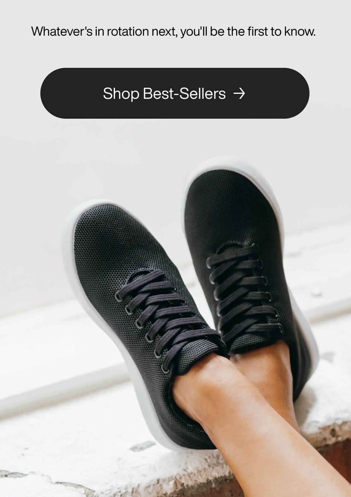 "Black sneakers on crossed legs, promoting best-sellers. Text reads, "Whatever's in rotation next, you'll be the first to know.""