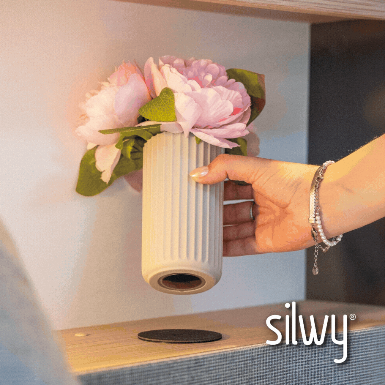Magnetic soap dispenser and magnetic toothbrush cup including pads