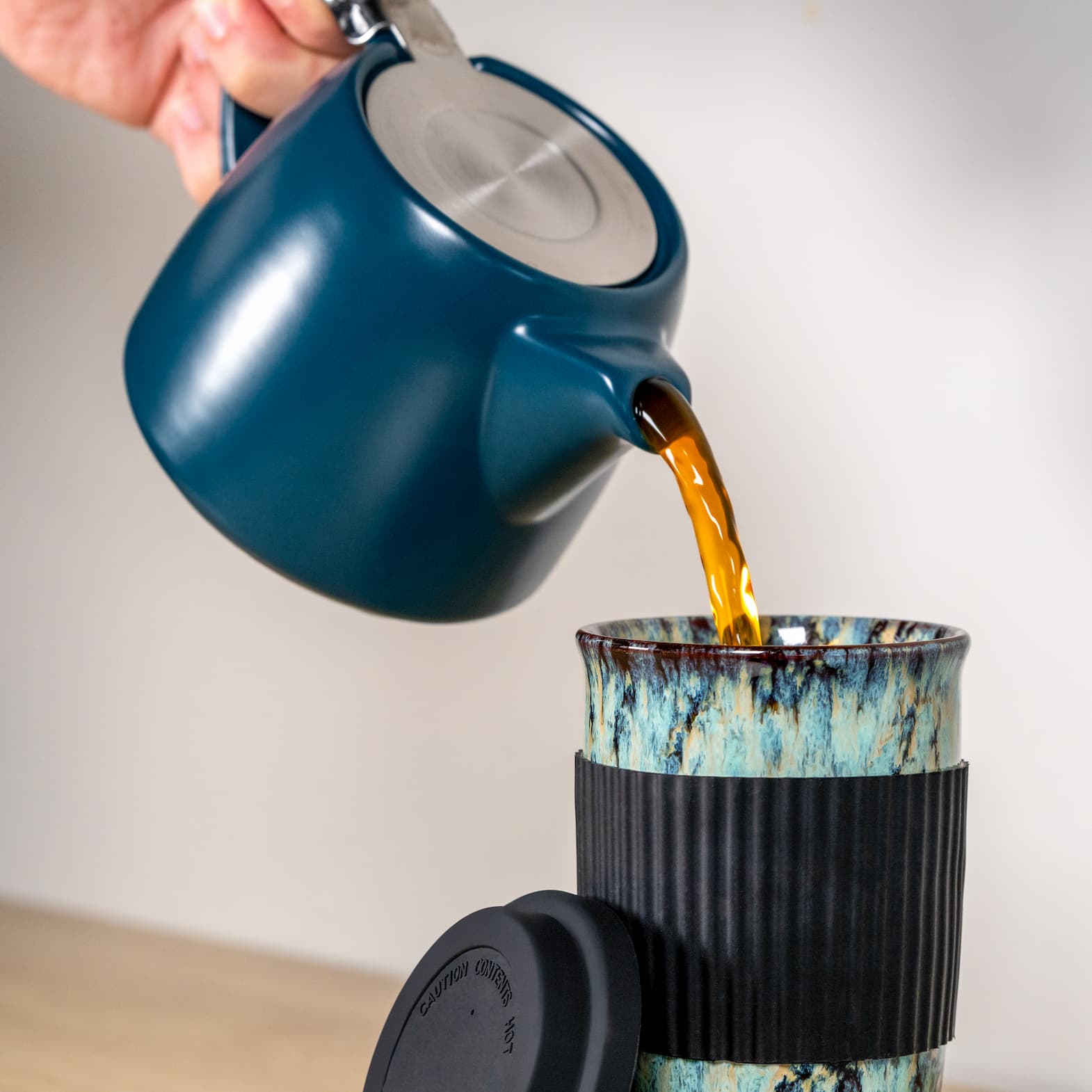 Pouring tea out of slate blue nordic teapot