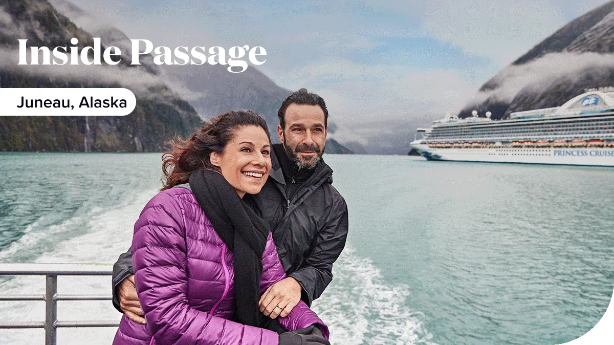 A couple looks out at Juneau, Alaska from the deck of a Princess ship.