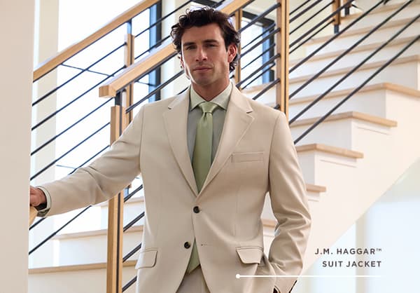 Man poses in a J.M. Haggar suit jacket