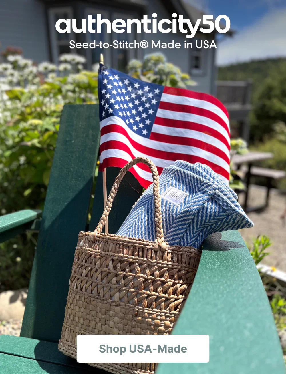 Handheld American flag and wrapped up Coastal Blue Heritage Blanket tucked in a basket on a back deck. Click or tap to shop USA-made.