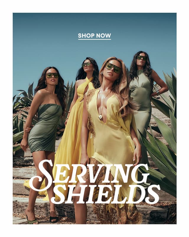 Shop Now. Image of women wearing green and yellow dresses wearing large pistachio-tinted shield sunglasses standing among succulents. Serving Shields.