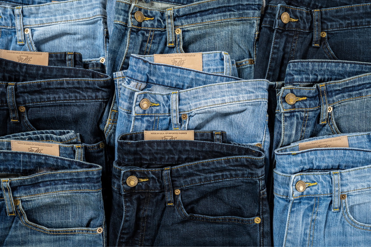 An array of 9 different tones of Bills Khakis denim pants shot from above