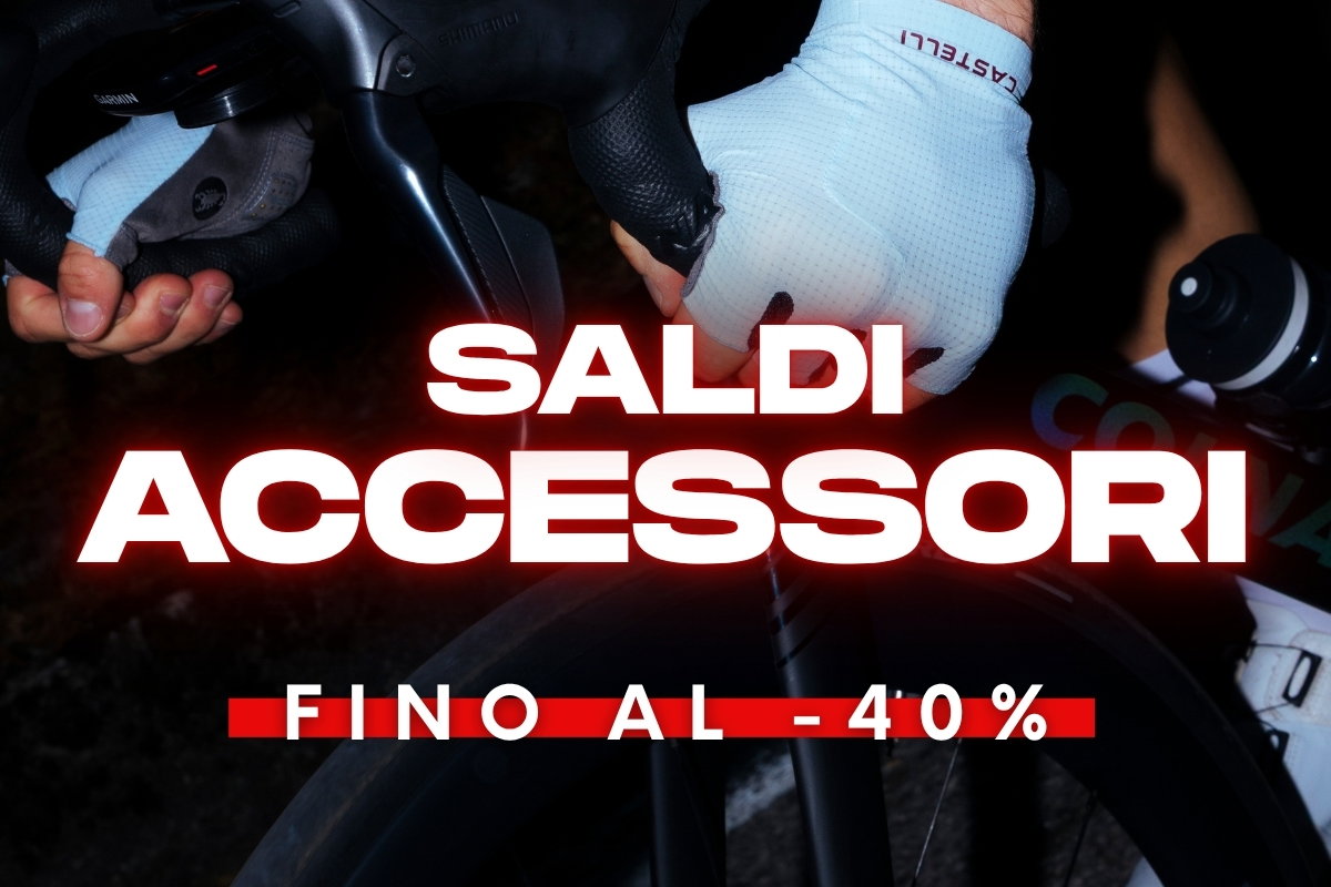 Close-up of cyclist's gloved hands on drop handlebars with water bottle and banner reading 'Sale: accessories up to 40% off'