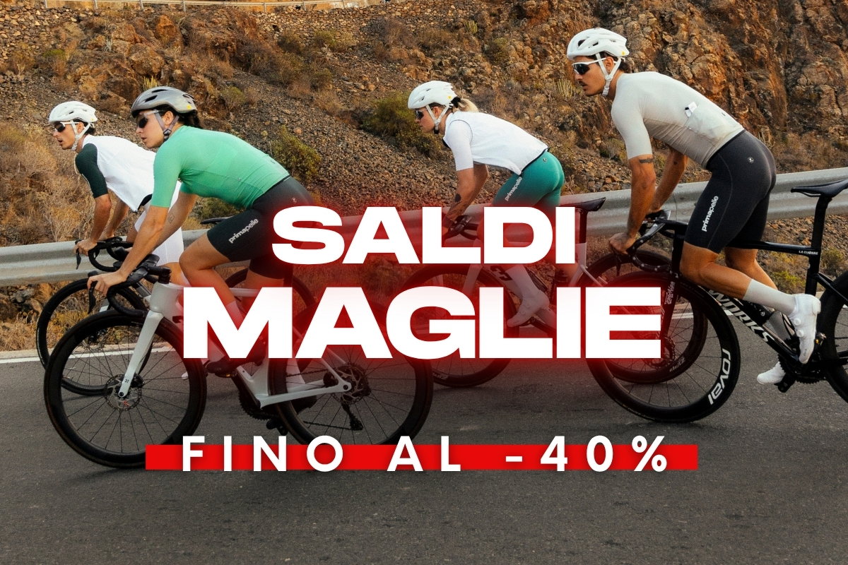 Group of four road cyclists riding on a mountain road wearing colourful cycling jerseys, overlay reads "Sale - up to 40% off jerseys"