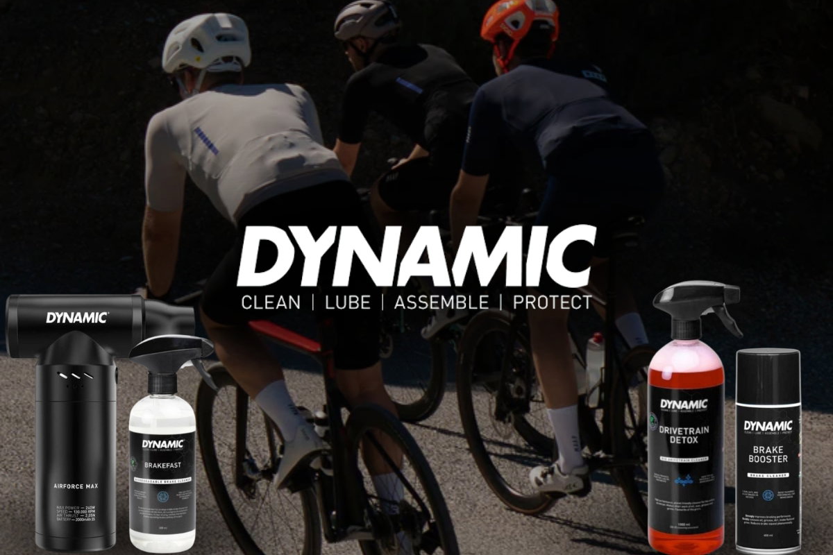 Cyclists riding on a sunlit road with DYNAMIC bike-care products (Airforce Max, Brakefast, Drivetrain Detox, Brake Booster) in foreground