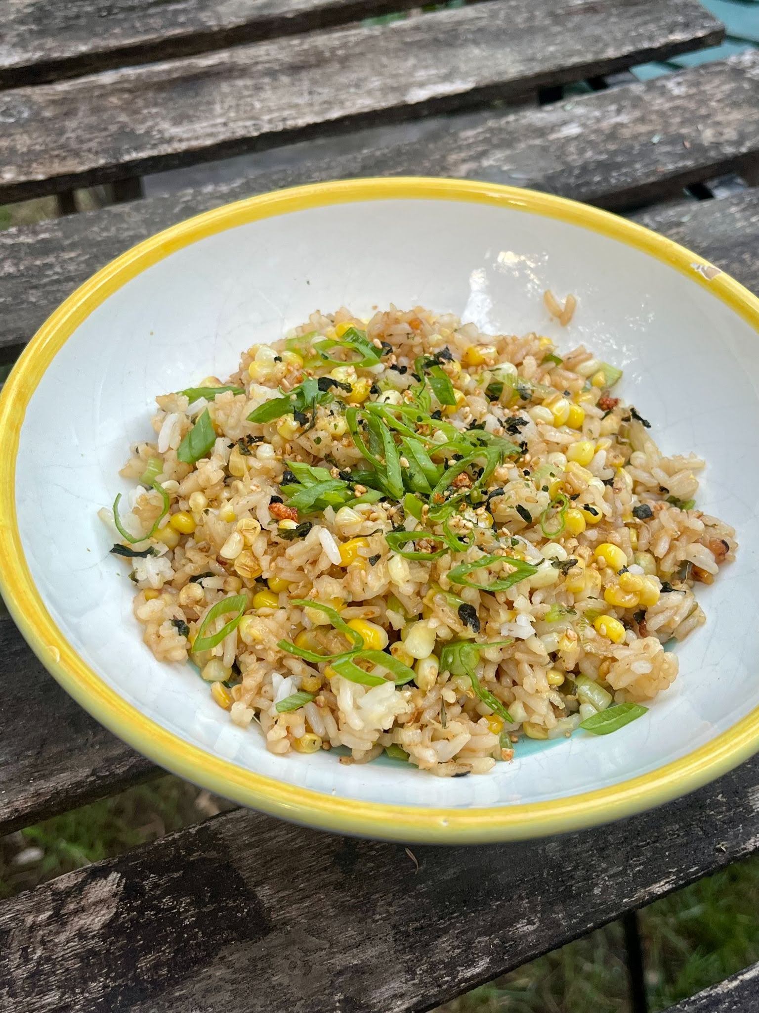 tofu on a white plate with a bowl of sauce on the left side