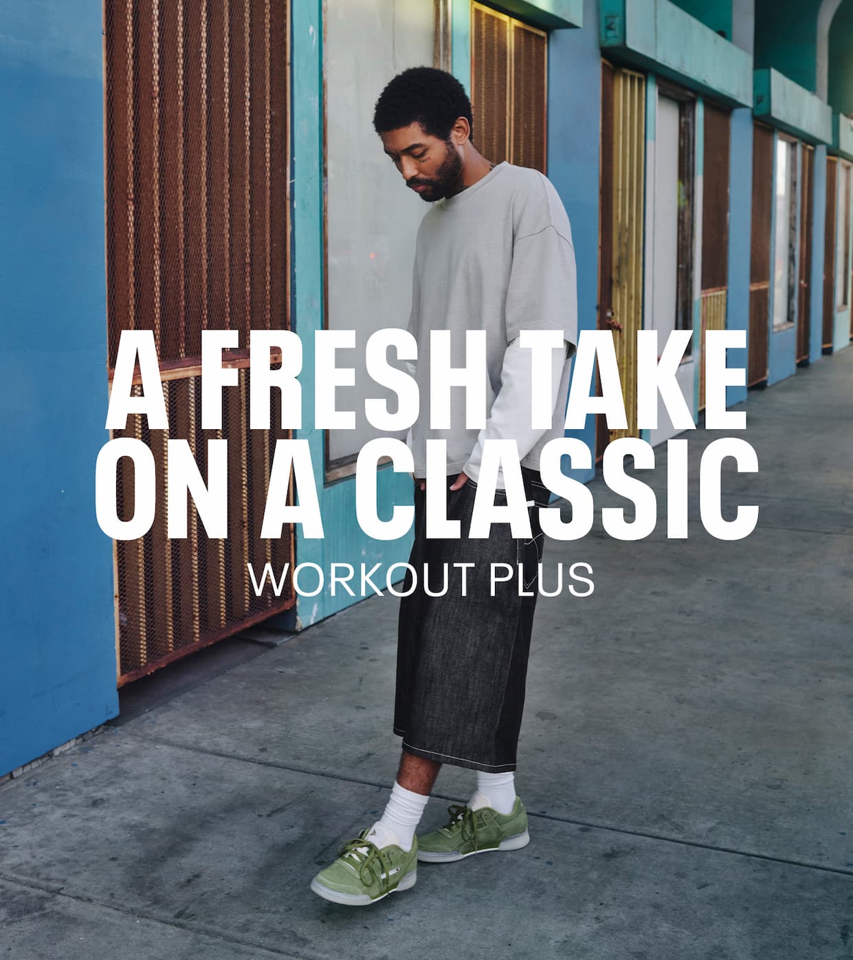 Person wearing olive green Workout Plus sneakers walks outdoors. Text reads: “A FRESH TAKE ON A CLASSIC. WORKOUT PLUS.”