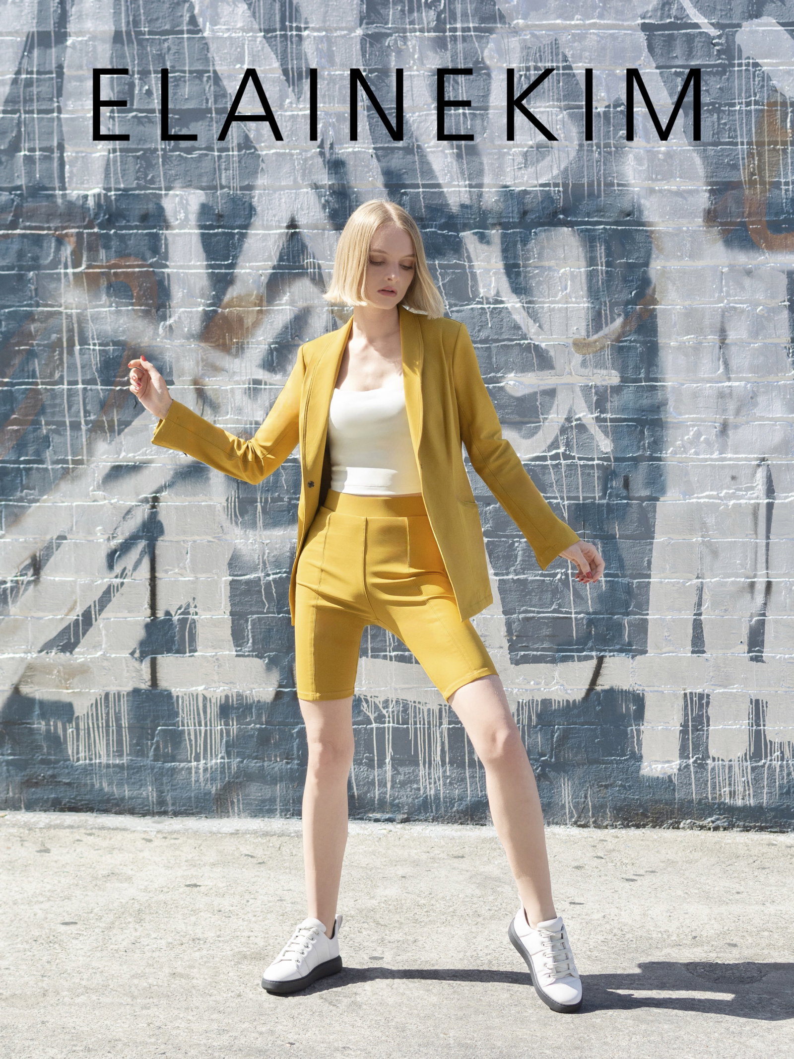 Woman wearing yellow blazer and shorts