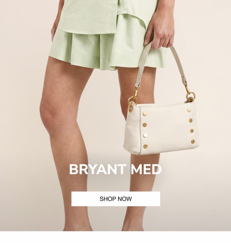 Model carrying the Hammitt Bryant Med in Calla Lily White pebbled leather.