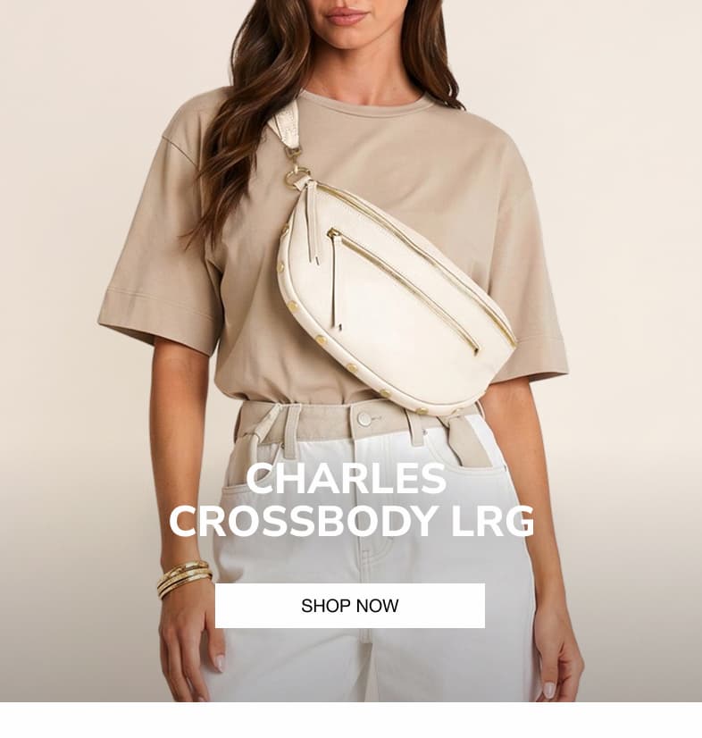 Model wearing the Hammitt Charles Crossbody Lrg in Calla Lily White pebbled leather.