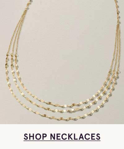 Multi-strand gold necklace with layered textured station chains.  Click here to shop necklaces