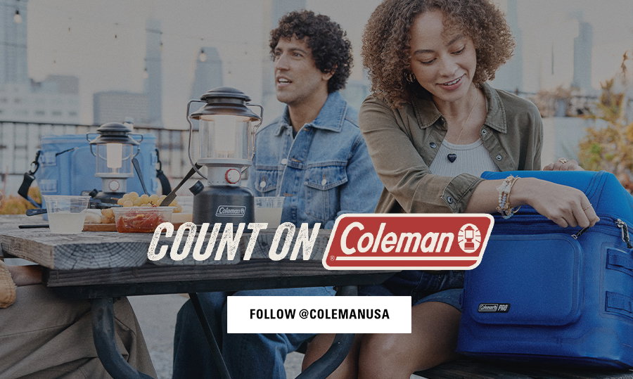 People sitting on a beach with coolers and camping gear, man playing guitar, Coleman logo, follow @colemanusa button